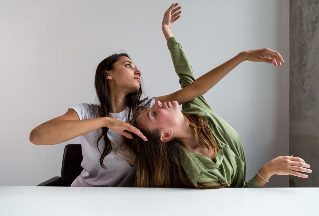 Two dancers in a contact improvisation-inspired pose