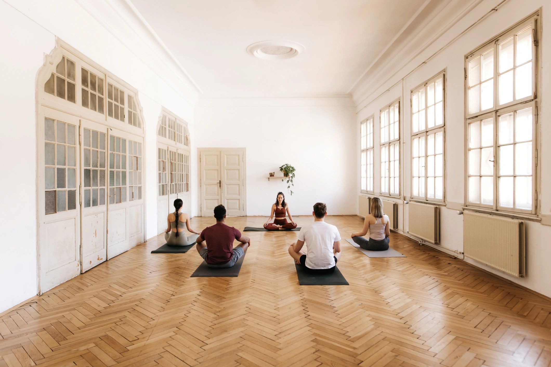 Group seated in a bright studio in a calm, mindful setting